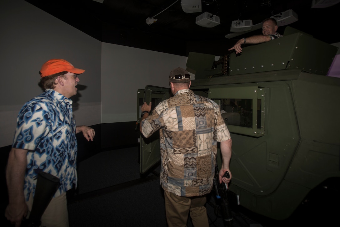 Faculty from the Massachusetts Institute of Technology and Stanford University, enter a Humvee in a Combat Convoy Simulator during a base tour aboard Marine Corps Base Hawaii on April 13, 2017. The group visited the base to build a better understanding of how the military operates in the Pacific. (U.S. Marine Corps photo by Lance Cpl. Isabelo Tabanguil)