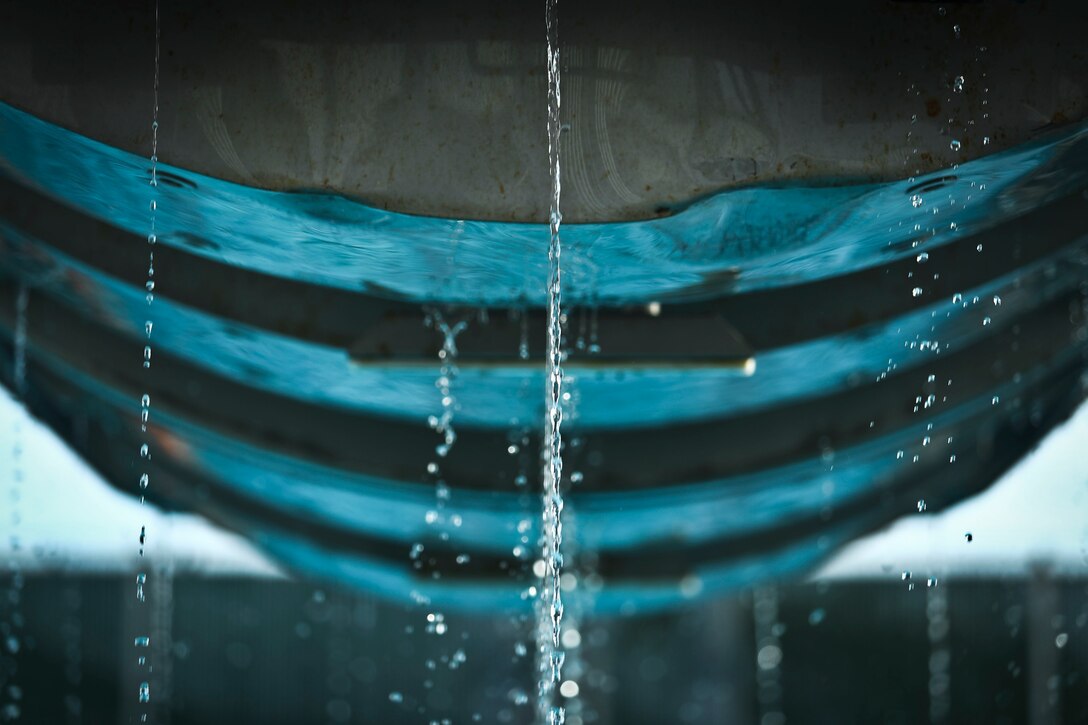 A Modular Amphibious Egress Trainer flips emerges from water during Helicopter Underwater Egress Training at the base pool, aboard Marine Corps Base Hawaii, March 23, 2017. The purpose of this training is to prepare service members for an emergency exit in case of a crash landing over water. (U.S. Marine Corps photo by Cpl. Aaron S. Patterson/released)