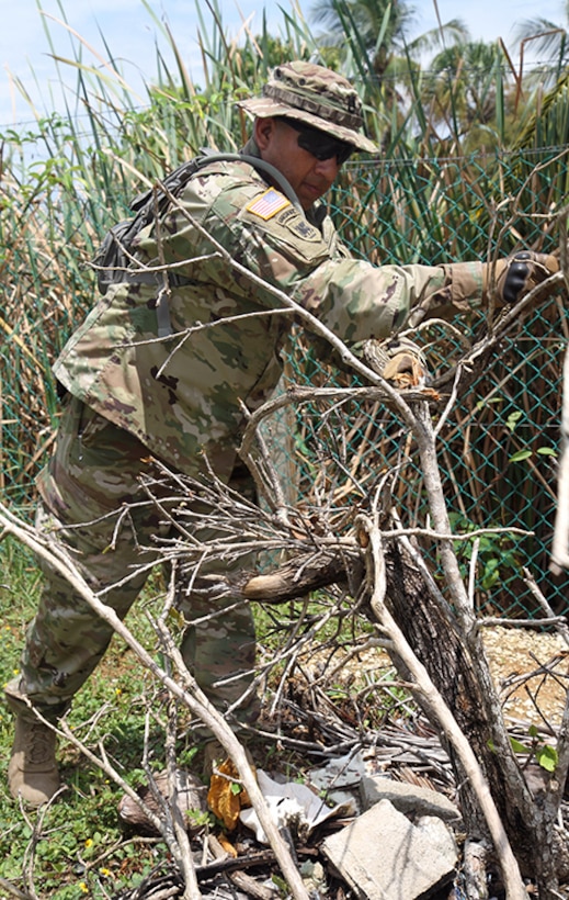 Sgt. 1st Class Jorge Palomo, a targeting non-commissioned officer with the 101st Information Operations Battalion, clears debris from the trees surrounding the houses at Liberty Children's Home April 18, 2017, during a community relations event held in Ladyville, Belize as part of Beyond the Horizon 2017.  BTH 2017 is a partnership exercise between the Government of Belize and U.S. Southern Command that will provide three free medical service events and five construction projects throughout the country of Belize from March 25 until June 17. (U.S. Army Photo by Staff Sgt. Fredrick Varney, 131st Mobile Public Affairs Detachment)