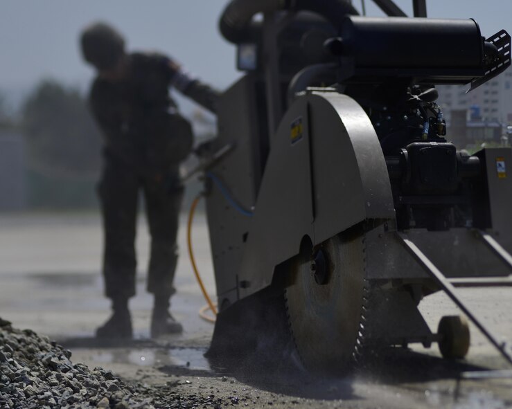 A Republic of Korea Airman cuts concrete during the U.S./ROK Combined Airfield Damage Repair Exercise at Daegu Air Base, April 19, 2017. The annual exercise ensures seamless interoperability between the U.S. and ROK while conducting airfield damage repair and improves their capability and commitment to work together at a moment’s notice. (U.S. Air Force photo by Staff Sgt. Alex Fox Echols III)