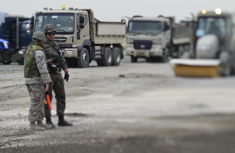 Republic of Korea Air Force Staff Sgt. Choi Seoung-bin, 11th Fighter Wing NCOIC equipment operations, speaks with U.S. Air Force Tech. Sgt. Travis Ridgley, 647th Civil Engineer Squadron crater chief, during the U.S./ROK Combined Airfield Damage Repair Exercise at Daegu Air Base, April 20, 2017. The annual exercise ensures seamless interoperability between the U.S. and ROK while conducting airfield damage repair and improves their capability and commitment to work together at a moment’s notice. (U.S. Air Force photo by Staff Sgt. Alex Fox Echols III)