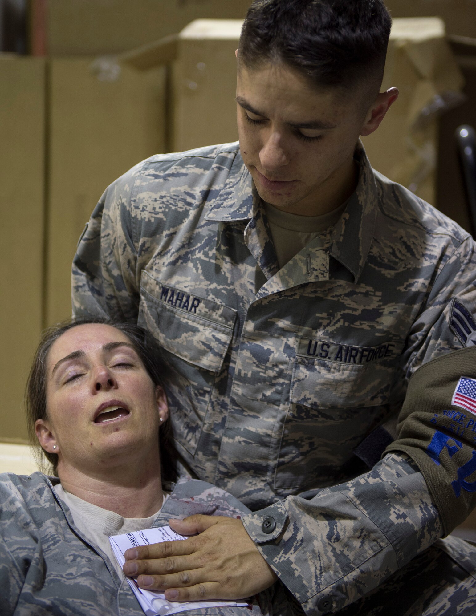 U.S. Air Force Senior Airmen Brandon Mahar, 379th Expeditionary Civil Engineer Squadron Force Protection Flight, gives self-aid buddy care to a victim of the active shooter exercise at Al Udeid Air Base, Qatar, April 17, 2017. The active shooter exercise tested the skills and abilities of Airmen to work with other units in in order to gain a better understanding of each other’s roles in the event of a real-world situation.   (U.S. Air Force photo by Tech. Sgt. Amy M. Lovgren)