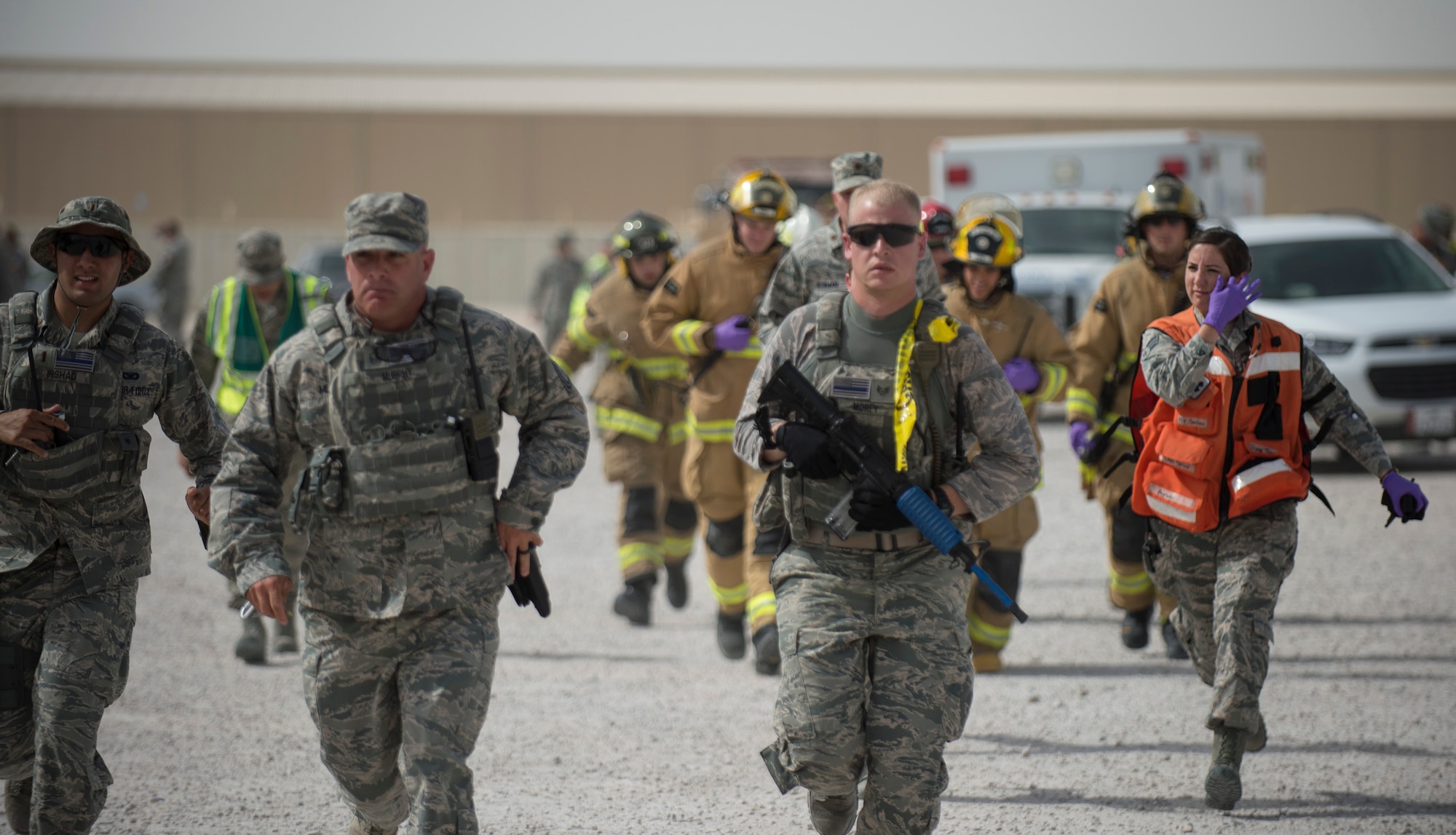 First responders from 379th Expeditionary Air Expeditionary Wing run to the scene of the active shooter exercise in order to administer medical treatment to victims at Al Udeid Air Base, Qatar, April 17, 2017. The active shooter exercise tested the skills and abilities of Airmen to work with other units in in order to gain a better understanding of each other’s roles in the event of a real-world situation.   (U.S. Air Force photo by Tech. Sgt. Amy M. Lovgren)
