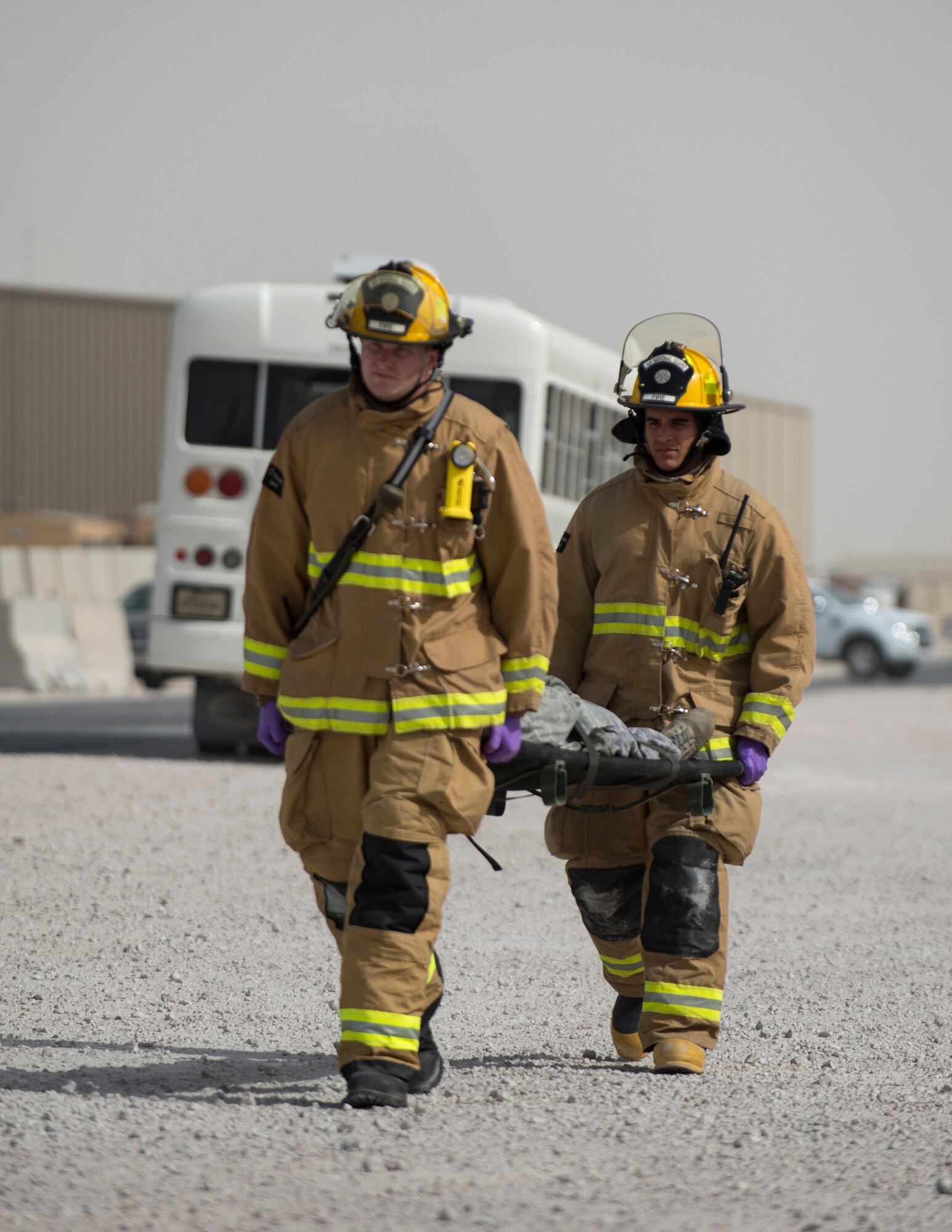 Fireman from the 379th Expeditionary Civil Engineer Squadron Fire Department carry a victim to the staging area at Al Udeid Air Base, Qatar, April 17, 2017. The active shooter exercise tested the skills and abilities of Airmen to work with other units in in order to gain a better understanding of each other’s roles in the event of a real-world situation.  (U.S. Air Force photo by Tech. Sgt. Amy M. Lovgren)