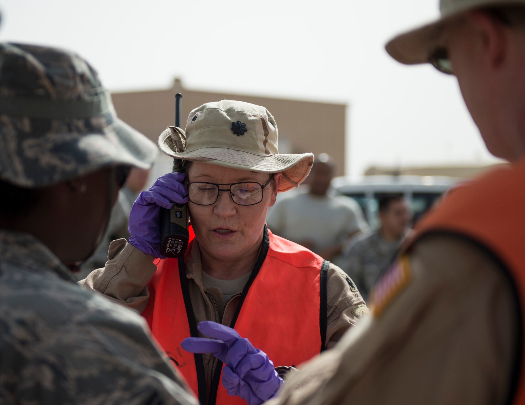 U.S. Air Force Lt. Col Oclla Fletcher, 379th Expeditionary Medical Group, uses a radio to confirm the number of simulated injured personal at Al Udeid Air Base, Qatar, April 17, 2017. The active shooter exercise tested the skills and abilities of Airmen to work with other units in in order to gain a better understanding of each other’s roles in the event of a real-world situation.   (U.S. Air Force photo by Tech. Sgt. Amy M. Lovgren)