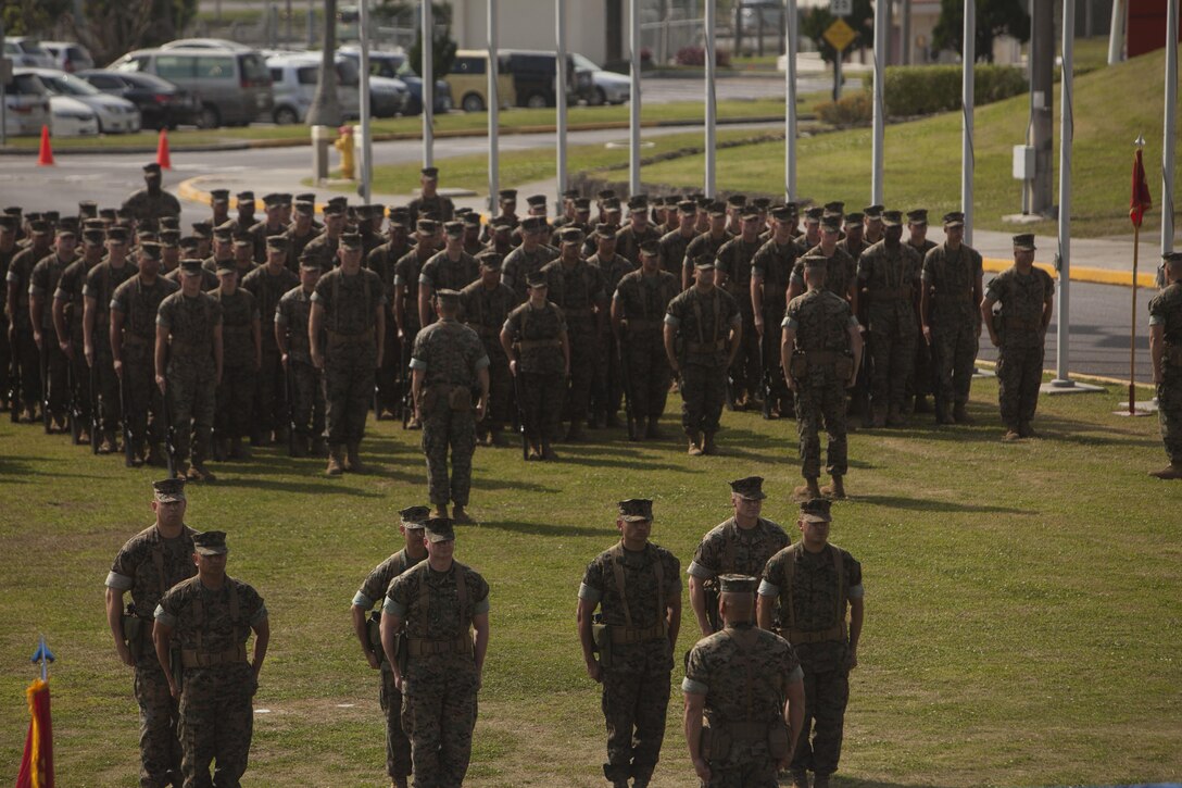 Marines with 1st Marine Aircraft Wing, stand at attention during a relief and appointment ceremony on Camp Foster, Okinawa, Japan, April 21, 2017. Relief and appointment ceremonies are part of the Marine Corps’ tradition in passing leadership from one to another. During the ceremony, Sgt. Maj. Michael J. Pritchard, from Keene, New Hampshire, was appointed sergeant major of 1st MAW, III Marine Expeditionary Force. Sgt. Maj. Mario A. Marquez, from Lakewood, California, is the outgoing sergeant major of 1st MAW and will soon assume his post as III MEF sergeant major. (U.S. Marine Corps Photo by Lance Cpl. Jonah Baase) 