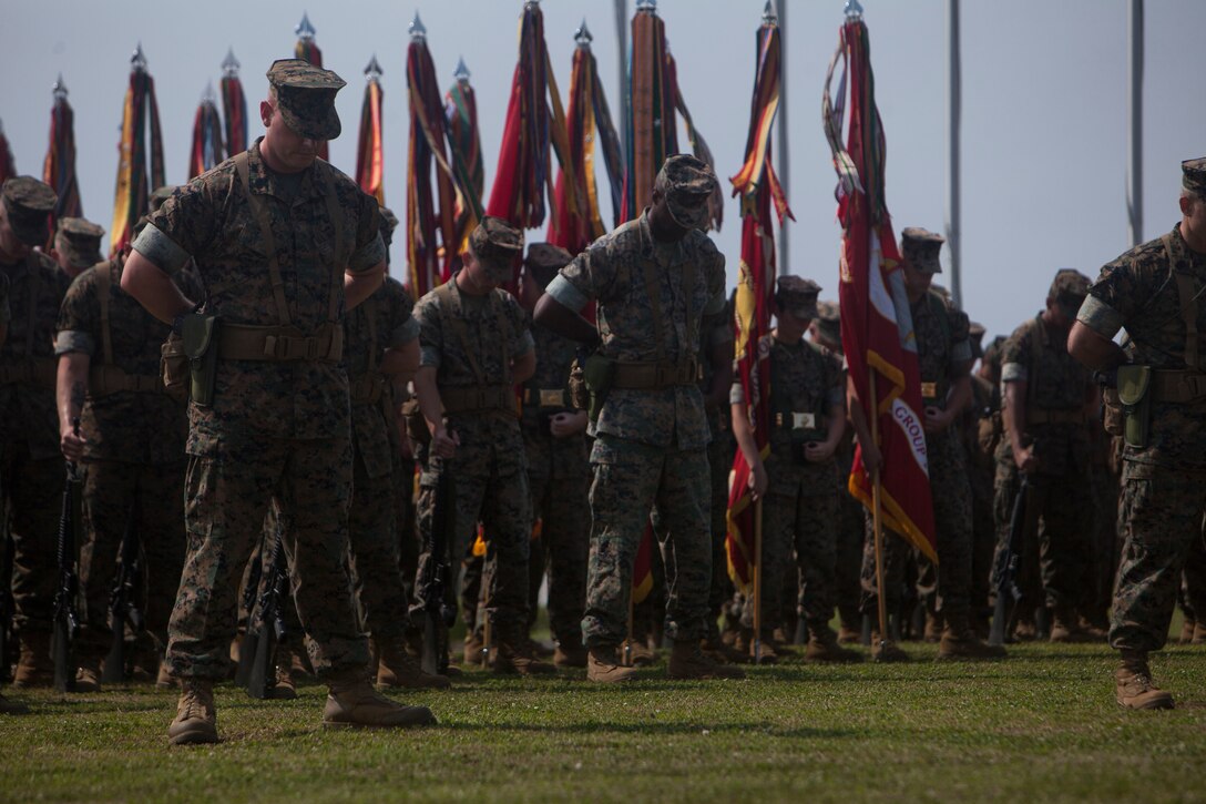 Marines with 1st Marine Aircraft Wing, bow their heads during a relief and appointment ceremony on Camp Foster, Okinawa, Japan, April 21, 2017. Relief and appointment ceremonies are part of the Marine Corps’ tradition in passing leadership from one to another. During the ceremony, Sgt. Maj. Michael J. Pritchard, from Keene, New Hampshire, was appointed sergeant major of 1st MAW, III Marine Expeditionary Force. Sgt. Maj. Mario A. Marquez, from Lakewood, California, was relieved as sergeant major of 1st MAW and will assume his post as III MEF sergeant major as his next assignment. (U.S. Marine Corps photo by Lance Cpl. Jonah Baase) 