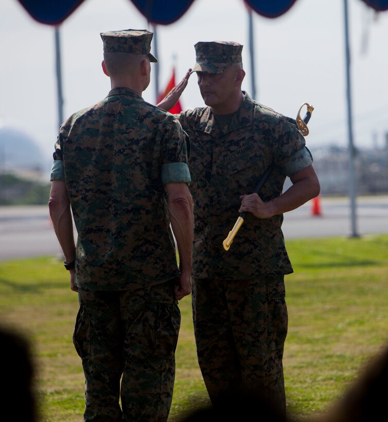 Sgt. Maj. Mario A. Marquez turns over the sword of office to Maj. Gen. Russell A. Sanborn during a relief and appointment ceremony on Camp Foster, Okinawa, Japan, April 21, 2017. Relief and appointment ceremonies are part of the Marine Corps’ tradition in passing leadership from one to another. During the ceremony, Sgt. Maj. Michael J. Pritchard, from Keene, New Hampshire, was appointed sergeant major of 1st Marine Aircraft Wing, III Marine Expeditionary Force. Marquez, from Lakewood, California, was the previous sergeant major of 1st MAW. Sanborn, from Gainesville, Florida, is the commanding general of 1st MAW. (U.S. Marine Corps photo by Lance Cpl. Jonah Baase) 