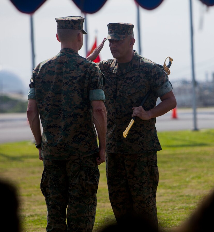 Sgt. Maj. Mario A. Marquez turns over the sword of office to Maj. Gen. Russell A. Sanborn during a relief and appointment ceremony on Camp Foster, Okinawa, Japan, April 21, 2017. Relief and appointment ceremonies are part of the Marine Corps’ tradition in passing leadership from one to another. During the ceremony, Sgt. Maj. Michael J. Pritchard, from Keene, New Hampshire, was appointed sergeant major of 1st Marine Aircraft Wing, III Marine Expeditionary Force. Marquez, from Lakewood, California, was the previous sergeant major of 1st MAW. Sanborn, from Gainesville, Florida, is the commanding general of 1st MAW. (U.S. Marine Corps photo by Lance Cpl. Jonah Baase) 