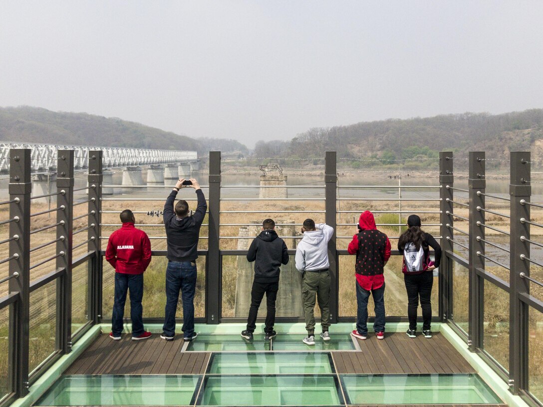 U.S. Marines with Marine Attack Squadron (VMA) 311 and Marine Aviation Logistics Squadron (MALS) 12, look over what was once a bridge that connected North Korea and South Korea during a tour to the Korean Demilitarized Zone, April 15, 2017. The tour included stops at the Joint Security Area, the Bridge of No Return and the Freedom Bridge. The Marines are temporarily in Korea in support of Max Thunder, an operational readiness exercise built to promote interoperability between U.S. and ROK forces. The trip was a way for the Marines to learn the countries’ history from the time of the Korean War to modern day. (U.S. Marine Corps photo by Lance Cpl. Carlos Jimenez)