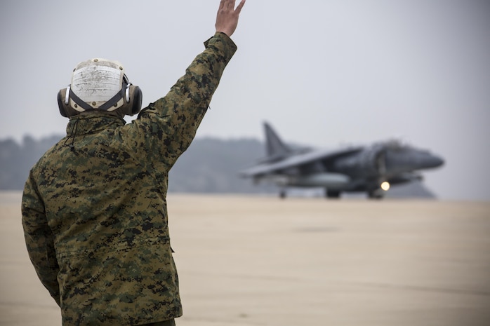 U.S. Marine Corps Lance Cpl. Jose Heredia, a powerline mechanic with Marine Attack Squadron (VMA) 311, signals an AV-8B Harrier during Exercise MAX THUNDER 17 at Kunsan Air Base, Republic of Korea, April 17, 2017. Max Thunder serves as an opportunity for U.S. and ROK forces to train together and sharpen tactical skills for the defense of the Asia-Pacific region. It is an annual military-flying exercise built to promote interoperability between U.S. and ROK forces. (U.S. Marine Corps photo by Lance Cpl. Carlos Jimenez)
