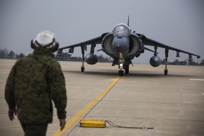 U.S. Marine Corps Lance Cpl. Jose Heredia, a powerline mechanic with Marine Attack Squadron (VMA) 311, signals an AV-8B Harrier during Exercise MAX THUNDER 17 at Kunsan Air Base, Republic of Korea, April 17, 2017. Max Thunder serves as an opportunity for U.S. and ROK forces to train together and sharpen tactical skills for the defense of the Asia-Pacific region. It is an annual military-flying exercise built to promote interoperability between U.S. and ROK forces. (U.S. Marine Corps photo by Lance Cpl. Carlos Jimenez)