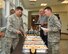 Chaplain (Maj.) Bradley Kimble, Deputy Wing Chaplain, hands Col. Douglas Gosney, 14th Flying Training Wing Commander, a biscuit during a prayer breakfast April 19, 2017, at Columbus Air Force Base, Mississippi. The Chapel provides refreshments to many community events to build relationships with Airmen around the base. (U.S. Air Force photo by Melissa Doublin)