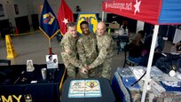 Brig. Gen. Steven Ainsworth, left, Command Sgt. Maj. Raymond Brown, right, and Spc. Jonathan Boyden, center, pose after cutting the Army Reserve birthday cake Friday, April 21 at the Kaiserslautern Military Community Center on Ramstein Air Base. The afternoon event was organized by the 7th Mission Support Command to celebrate the 109th Army Reserve birthday. 