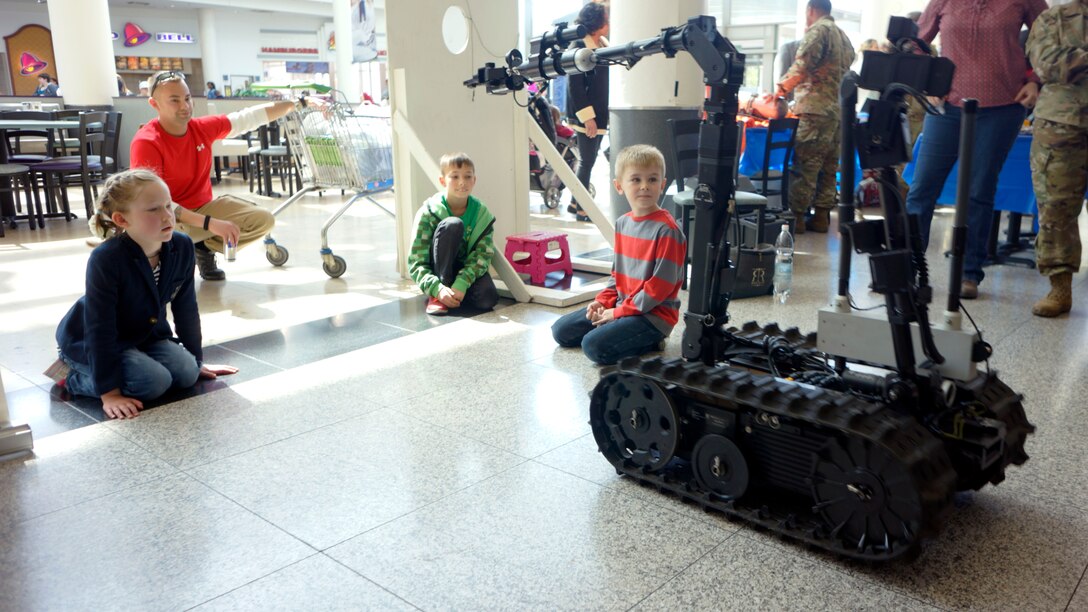 Children and adults enjoy the 773rd Civil Support Team's surveying robots Friday, April 21 at the Kaiserslautern Military Community Center on Ramstein Air Base. The afternoon event was organized by the 7th Mission Support Command to celebrate the 109th Army Reserve birthday. 