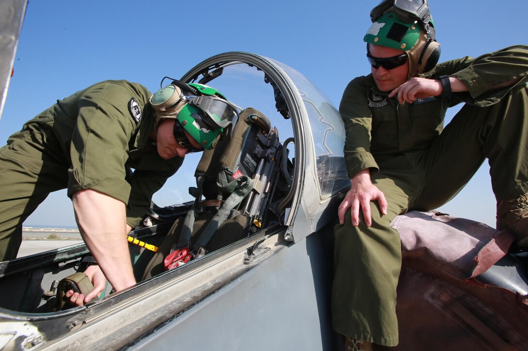 U.S. Marine Corps Sgt. Paul Daniels and Lance Cpl. Nathan Derouin, safety equipment mechanics deployed in support of Combined Joint Task Force – Operation Inherent Resolve, assigned to Marine Attack Squadron 231, Special Purpose Marine Air-Ground Task Force-Crisis Response-Central Command, replace an ejection seat in an AV-8B Harrier, Feb. 27, 2017. SPMAGTF-CR-CC continues its commitment to support OIR and USCENTCOM through employment of kinetic air strike missions, security cooperation and crisis response assets within the region. CJTF-OIR is the global Coalition to defeat ISIS in Iraq and Syria. (U.S. Marine Corps photo by Staff Sgt. Jennifer B. Poole)