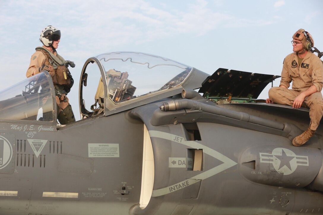 U.S. Marine Corps Lance Cpl. Tyler Summ, a fixed wing aircraft mechanic deployed in support of Combined Joint Task Force – Operation Inherent Resolve, assigned to Marine Attack Squadron 231, Special Purpose Marine Air-Ground Task Force-Crisis Response-Central Command, speaks with an AV-8B Harrier pilot after returning from a flight, March 2, 2017. SPMAGTF-CR-CC continues its commitment to support OIR and USCENTCOM through employment of kinetic air strike missions, security cooperation and crisis response assets within the region. CJTF-OIR is the global Coalition to defeat ISIS in Iraq and Syria. (U.S. Marine Corps photo by Staff Sgt. Jennifer B. Poole)