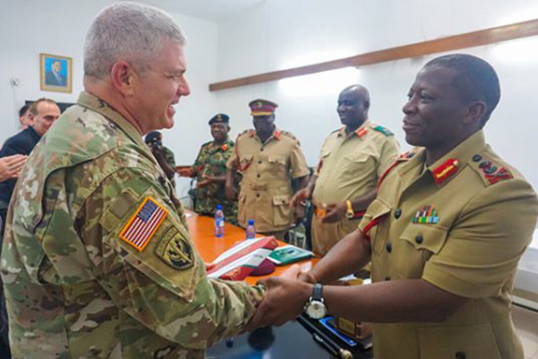 Army Brig. Gen. Kenneth Moore, deputy commander of U.S. Army Africa, shakes hands with Malawi Gen. Griffin Phiri, chief of the Malawi Armed Forces, after a briefing at the Kumuzu Barracks, Lilongwe, Malawi, during the final planning event for the Africa Land Forces Summit 2017. The summit is an annual seminar bringing together land force chiefs from across Africa to discuss and develop cooperative solutions to regional and trans-regional challenges and threats. Army photo by Capt. Jason Welch
