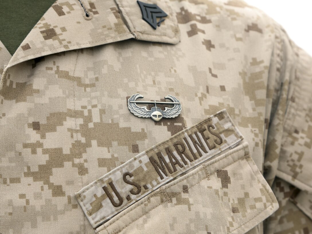U.S. Marine Corps Sgt. Joshua Greentaylor, the air cell operations chief with Special Purpose Marine Air-Ground Task Force-Crisis Response-Central Command, brandishes his newly earned air assault badge while forward deployed in the Middle East, April 15, 2017. The course prepares graduates for insertion, evacuation and pathfinder missions.  SPMAGTF-CR-CC is a well-trained crisis response unit that has the ability to project combat power over vast distances using organic aviation, logistical, and ground combat assets. (U.S. Marine Corps photo by Lance Cpl. Joshua McAlpine)
