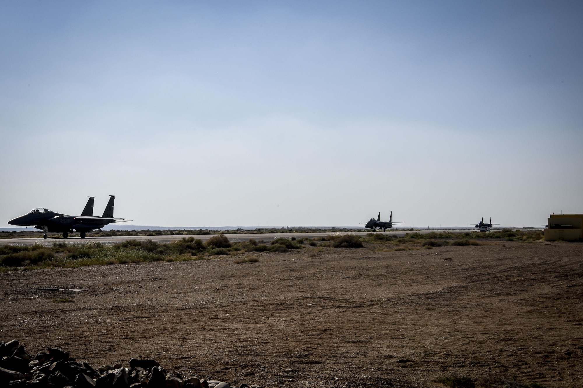 Three F-15 Strike Eagles taxi on a runway an undisclosed location in Southwest Asia, April 7, 2017. The jets are deployed from the 492nd Fighter Squadron at RAF Lakenheath, England. These Strike Eagles have taken over for those that belong to the 389th Expeditionary Fighter Squadron that was deployed to the 332nd Air Expeditionary Wing for the last six months. (U.S. Air Force photo by Tech Sgt. Eboni Reams)
