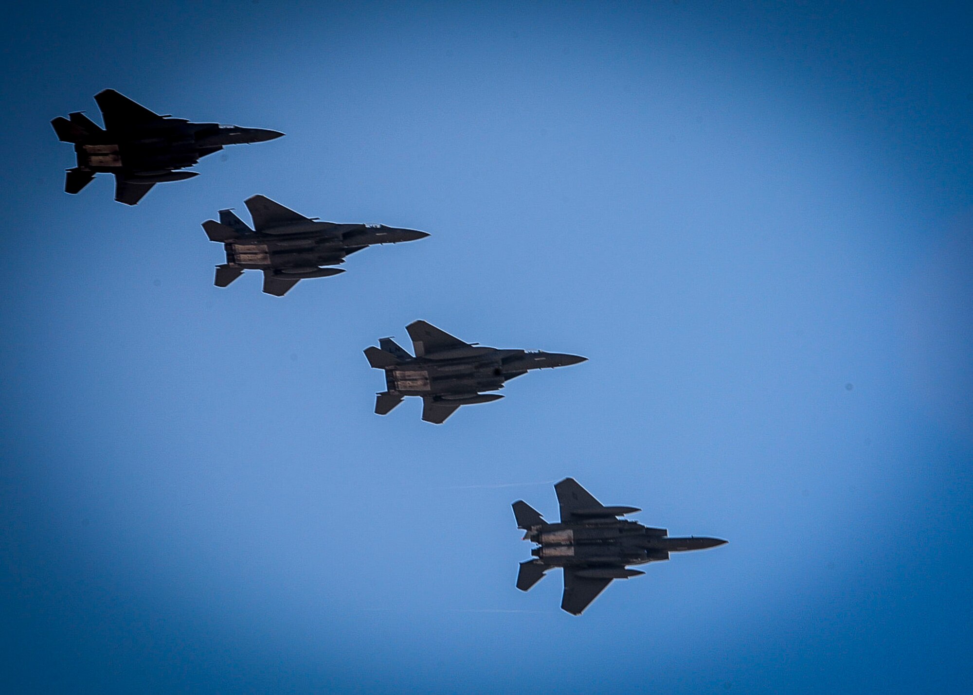 Four F-15E Strike Eagles fly over an undisclosed location in Southwest Asia, April 7, 2017. The jets are deployed from the 492nd Fighter Squadron at RAF Lakenheath, England. These Strike Eagles have taken over for those that belong to the 389th Expeditionary Fighter Squadron that was deployed to the 332nd Air Expeditionary Wing for the last six months. (U.S. Air Force photo by Tech Sgt. Eboni Reams)