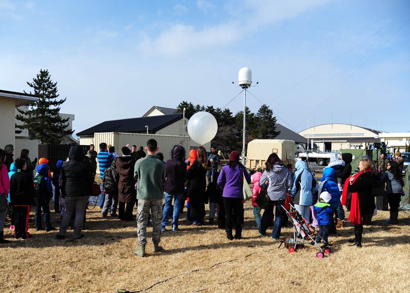More than 50 home-schooled students and their families wait patiently as a weather balloon is about to be released as part of the U.S. Marine Corps Meteorology and Oceanography analyst forecasters, 10-day exercise at Misawa Air Base, Japan, March 24, 2017. The exercise provided the Marines from Iwakuni, Japan, with simulated cold weather field conditions and prepared them for future deployments. (U.S. Air Force photo by Tech. Sgt. April Quintanilla)