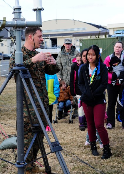U.S. Marine Corps Gunnery Sgt. Noah Naifeh, Meteorology and Oceanography weather forecaster, explains to a small group of home-schooled students and their families the weather radar’s functions and capabilities at Misawa Air Base, Japan, March 24, 2017. Despite their workload and long hours, the METOC Marines from Iwakuni, Japan, took the time to host more than 50 home-schooled students and their families as they visited the 35th Operations Support Squadron weather section. (U.S. Air Force photo by Tech. Sgt. April Quintanilla)