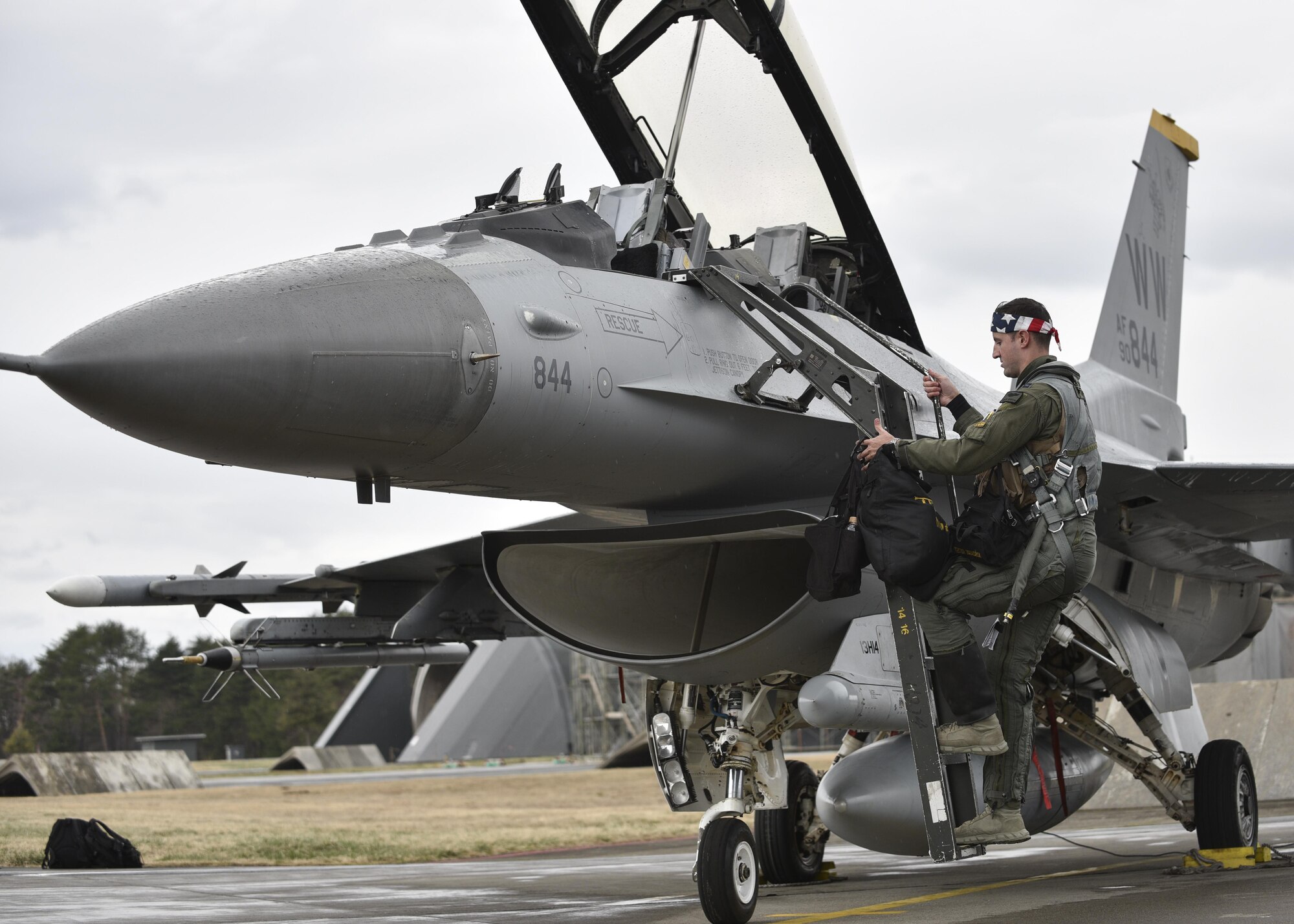 U.S. Air Force Capt. Dakota Newton, a 14th Fighter Squadron standards and evaluations liaison officer, climbs a ladder to the cockpit of an F-16 Fighting Falcon prior to the start of a bilateral exercise at Misawa Air Base, April 19, 2017. Exercises such as this enhance inoperability between the Air Force and Japan Air Self-Defense Forces and showcase the long standing military partnership and commitment between the two nations ensuring security and stability throughout the Indo Asia Pacific region. (U.S. Air Force photo by Staff Sgt. Melanie A. Hutto)
