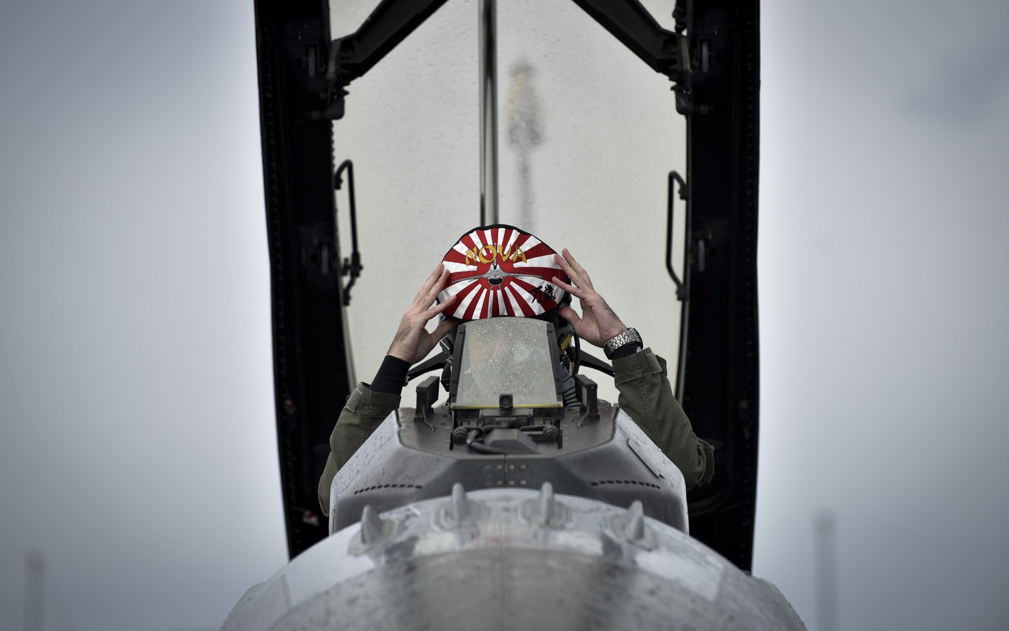 U.S. Air Force Capt. Dakota Newton, a 14th Fighter Squadron standards and evaluations liaison officer,  prepares to don his helmet prior to take off to participate in a bilateral exercise at Misawa Air Force Base, Japan, April 19, 2017. The bi-annual exercise incorporates a multitude of aircraft from the U.S. Air Force and Japanese Air Forces into air-to-air combat and suppression of enemy forces scenarios. The 35th Fighter Wing operates a fleet of more than 40 combat-ready aircraft to perform air superiority functions at a moment’s notice in compliance with war time contingencies. (U.S. Air Force photo by Staff Sgt. Melanie A. Hutto)