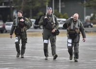 Three 14th Fighter Squadron pilots walk toward their F-16 Fighting Falcon to prepare for take off from Misawa Air Base, Japan, prior to the start of a bilateral exercise, April 19, 2017. The bi-annual training exercise incorporates a multitude of aircraft from the U.S. and Japanese fleet into air to air combat and suppression of enemy forces scenarios. Operating from a key strategic hub in the Asia-Pacific region, the 35t Fighter Wing defends U.S. and Japan mutual interest by providing a forward a forward power projection platform with integrated, deployable, combat power. (U.S. Air Force photo by Staff Sgt. Melanie A. Hutto) 