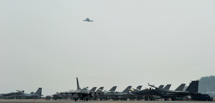 An F-16 Fighting Falcon from the 80th Fighter Squadron taxis down the flightline while a McDonnell F-4E Phantom II jet from the 17th Fighter Squadron, Chung Ju Air Base, Republic of Korea, takes off during Exercise MAX THUNDER 17 at Kunsan Air Base, Republic of Korea, April 18, 2017. In Max Thunder, U.S. and ROK air forces consistently train together to be ready around-the-clock to defend the Republic of Korea. (U.S. Air Force photo by Senior Airman Colville McFee/Released)
