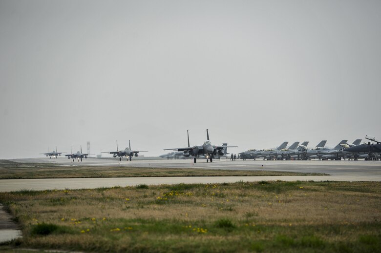 Republic of Korea Air Force F-15K Slam Eagles from the 11th Fighter Squadron, Daegu Air Base, ROK, taxis down the flightline during Exercise MAX THUNDER 17 at Kunsan Air Base, Republic of Korea, April 18, 2017. Max Thunder is part of a continuous exercise program to enhance interoperability between U.S. and ROK forces. These exercises highlight the long-standing military partnership, commitment and enduring friendship between two nations, which help to ensure security on the Korean Peninsula, and reaffirm the U.S. commitment to stability in the Northeast Asia region. (U.S. Air Force photo by Senior Airman Colville McFee/Released)