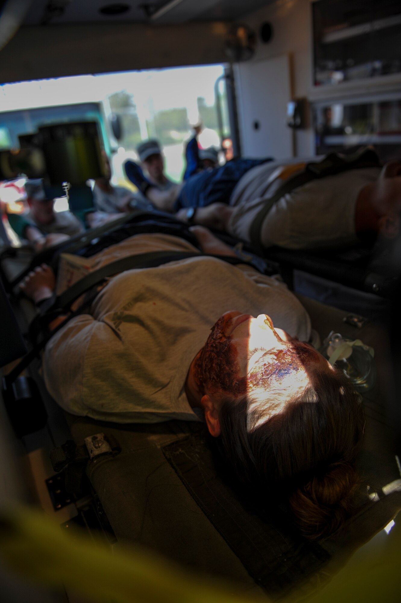 United States Air Force Senior Airman Amber Lucas, 8th Medical Operations Squadron dental technician, lies on a stretcher inside of an ambulance after receiving care during a mass casualty exercise at Kunsan Air Base, Republic of Korea, April 19, 2017. U.S. and ROK airmen conducted the training to evaluate their ability to communicate and operate through a MASCAL situation. (U.S. Air Force photo by Senior Airman Colville McFee/Released)