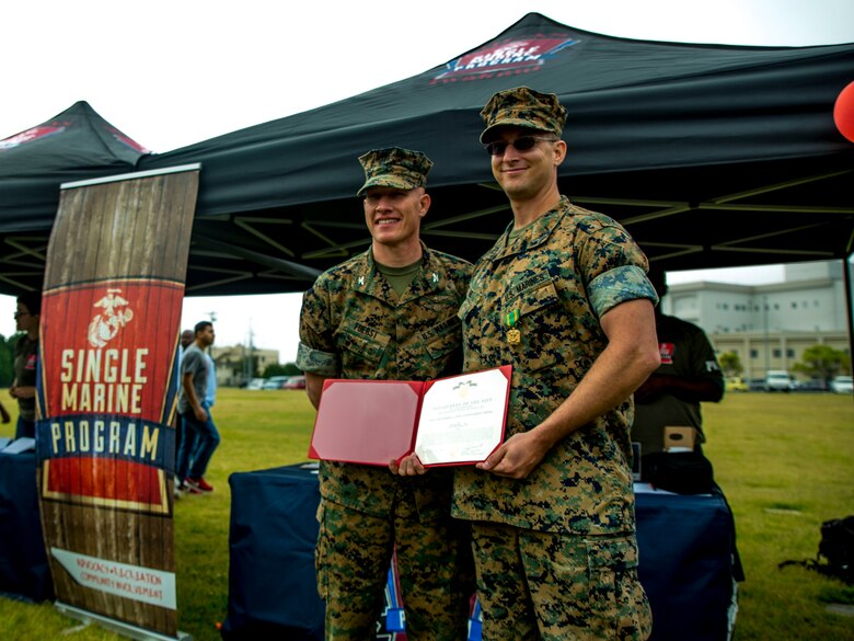 U.S. Marine Corps Col. Richard F. Fuerst, left, commanding officer of Marine Corps Air Station Iwakuni, poses with Sgt. Kevin Lage, president of the Single Marine Program, during the 3rd Annual SMP’s Days of Service Clean-Up Day at MCAS Iwakuni, Japan, April 21, 2017. Lage was awarded the Navy and Marine Corps Achievement Medal for his volunteer work at SMP and to the community. (U.S. Marine Corps photo by Pfc. Stephen Campbell)