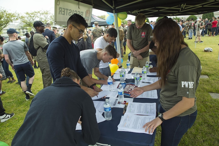Volunteers sign up to participate in the 3rd Annual Single Marine Program’s Days of Service Clean-Up Day at Marine Corps Air Station Iwakuni, Japan, April 21, 2017. Each day of the week volunteer service members spent time supporting the community by visiting a local Iwakuni nursing home, cutting and sorting coupons, teaching and playing chess with local Japanese students, and cleaning and walking dogs at the base kennel.  Clean-up Day was the finale dedicated to bringing all the volunteers together to recognize and celebrate their contribution to the community.  (U.S. Marine Corps photo by Pfc. Stephen Campbell)
