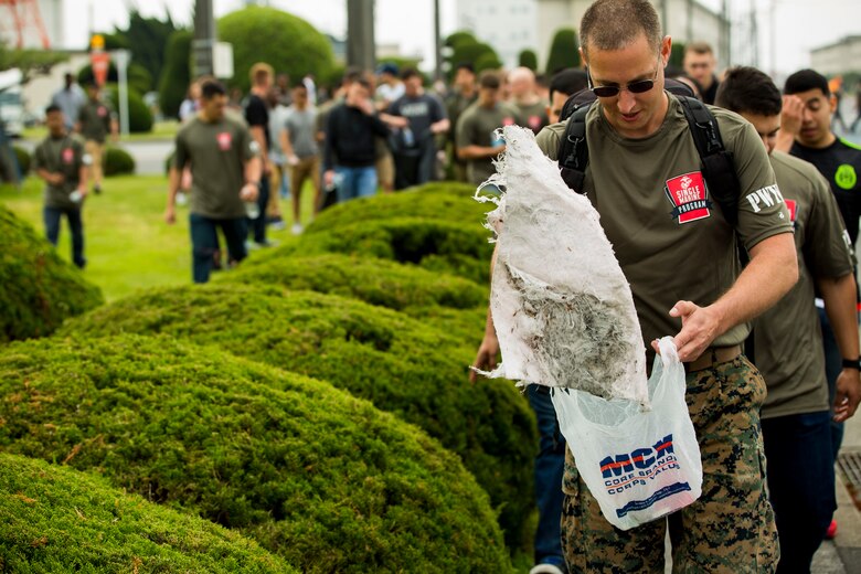 U.S. Marine Corps Sgt. Kevin Lage, the Single Marine Program’s president for Marine Corps Air Station Iwakuni, picks up trash during the 3rd Annual Single Marine Program’s Days of Service Clean-Up Day at MCAS Iwakuni, Japan, April 21, 2017. Each day of the week volunteer service members spent time supporting the community by visiting a local Iwakuni nursing home, cutting and sorting coupons, teaching and playing chess with local Japanese students, and cleaning and walking dogs at the base kennel.  Clean-up Day was the finale dedicated to bringing all the volunteers together to recognize and celebrate their contribution to the community.  (U.S. Marine Corps photo by Pfc. Stephen Campbell)