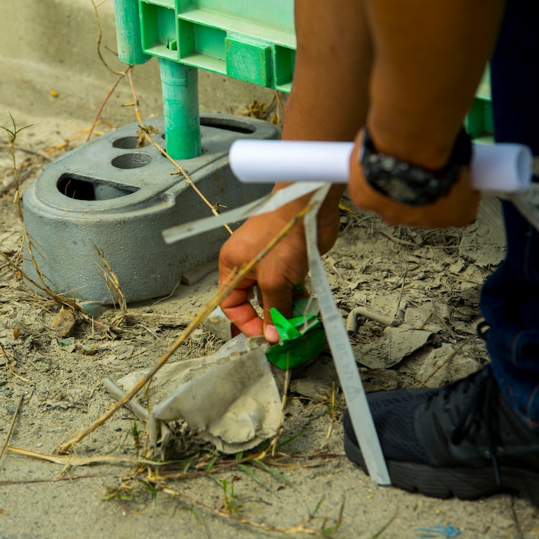 A volunteer with the 3rd Annual Single Marine Program’s Days of Service Clean-Up Day, picks up trash off the side of a road at Marine Corps Air Station Iwakuni, Japan, April 21, 2017. Each day of the week volunteer service members spent time supporting the community by visiting a local Iwakuni nursing home, cutting and sorting coupons, teaching and playing chess with local Japanese students, and cleaning and walking dogs at the base kennel. Clean-Up Day was the finale dedicated to bringing all the volunteers together to recognize and celebrate their contribution to the community. (U.S. Marine Corps photo by Pfc. Stephen Campbell)