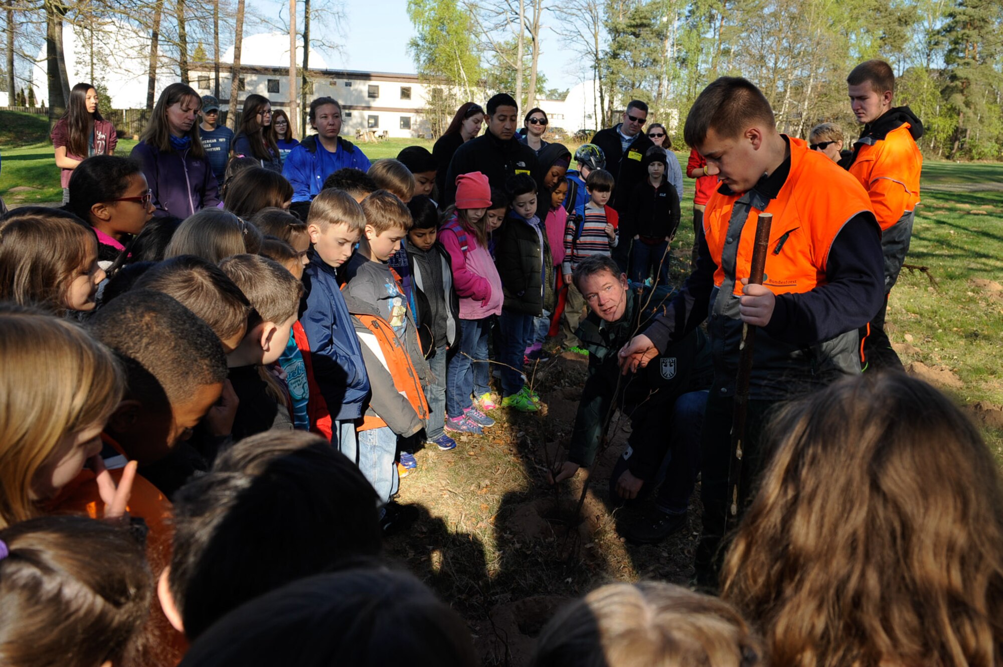 Federal forest departments show students from the Kaiserslautern Military Community the correct way to plant a tree during an Earth Day tree planting celebration on Ramstein Air Base, Germany, April 21, 2017. Students celebrated Earth Day, demonstrating support for environmental protection by planting trees. (U.S. Air Force photo by Airman 1st Class Savannah L. Waters)