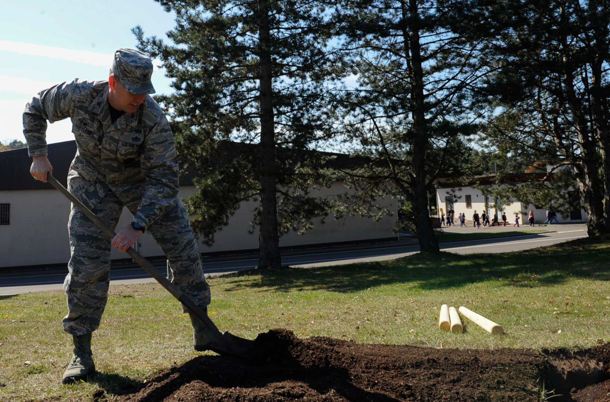 Col. Brian Hartless, 86th Civil Engineer Group commander, shovels dirt to plant a tree on Ramstein Air Base, Germany, April 21, 2017. The 86th CEG leadership and federal forest departments planted trees to celebrate Earth Day and raise awareness for environmental protection. (U.S. Air Force photo by Airman 1st Class Savannah L. Waters)