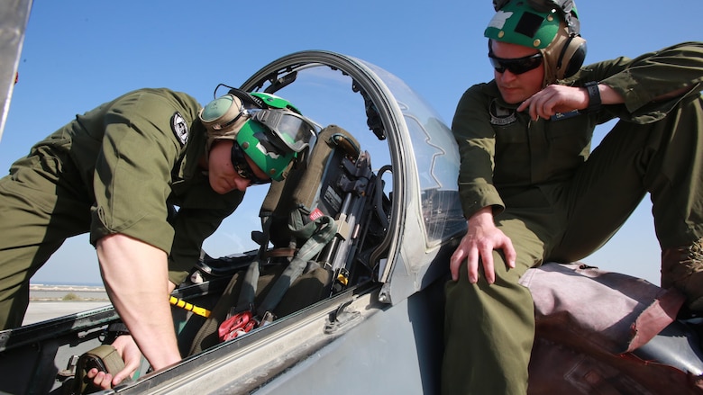 U.S. Marine Corps Sgt. Paul Daniels and Lance Cpl. Nathan Derouin, safety equipment mechanics deployed in support of Combined Joint Task Force – Operation Inherent Resolve, assigned to Marine Attack Squadron 231, Special Purpose Marine Air-Ground Task Force-Crisis Response-Central Command, replace an ejection seat in an AV-8B Harrier, Feb. 27, 2017. SPMAGTF-CR-CC continues its commitment to support OIR and USCENTCOM through employment of kinetic air strike missions, security cooperation and crisis response assets within the region. CJTF-OIR is the global Coalition to defeat ISIS in Iraq and Syria. 