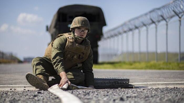 U.S. Marine Corps Lance Cpl. Ryan Miston, a combat engineer with Marine Wing Support Squadron 171, monitors a hose as it pumps water into a drainage ditch during airfield damage and repair training at Marine Corps Air Station Iwakuni, Japan, April 19, 2017. The ADR training required Marines to utilize their skill set to tactically and proficiently fix any anomalies to a simulated damaged airfield. The training focused on becoming more efficient in situations that may require Marines to act in real-world scenarios to maintain the tempo of aircraft operations.
