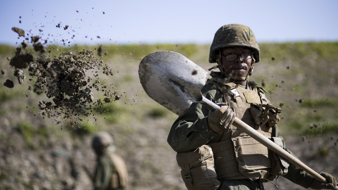 U.S. Marine Corps Pfc. Jason Taylor, a combat engineer with Marine Wing Support Squadron 171, shovels dirt and mud during airfield damage and repair training at Marine Corps Air Station Iwakuni, Japan, April 19, 2017. The ADR training required Marines to utilize their skill set to tactically and proficiently fix any anomalies to a simulated damaged airfield. The training focused on becoming more efficient in situations that may require Marines to act in real-world scenarios to maintain the tempo of aircraft operations.