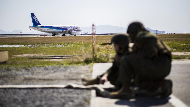 U.S. Marines with Marine Wing Support Squadron 171, monitor a hose as it pumps water into a drainage ditch during airfield damage and repair training at Marine Corps Air Station Iwakuni, Japan, April 19, 2017. The ADR training required Marines to utilize their skill set to tactically and proficiently fix any anomalies to a simulated damaged airfield. The training focused on becoming more efficient in situations that may require Marines to act in real-world scenarios to maintain the tempo of aircraft operations.