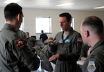 Wyoming Air National Guard Lt. Col. Ryan Scofield, MAFFS instructor pilot, discusses an upcoming training sortie with members of Nevada Air National Guard's 152nd Airlift Wing. Members of all four MAFFS-designated wings came together for annual certification and training in Boise, Idaho, April 19-24, 2017. 
