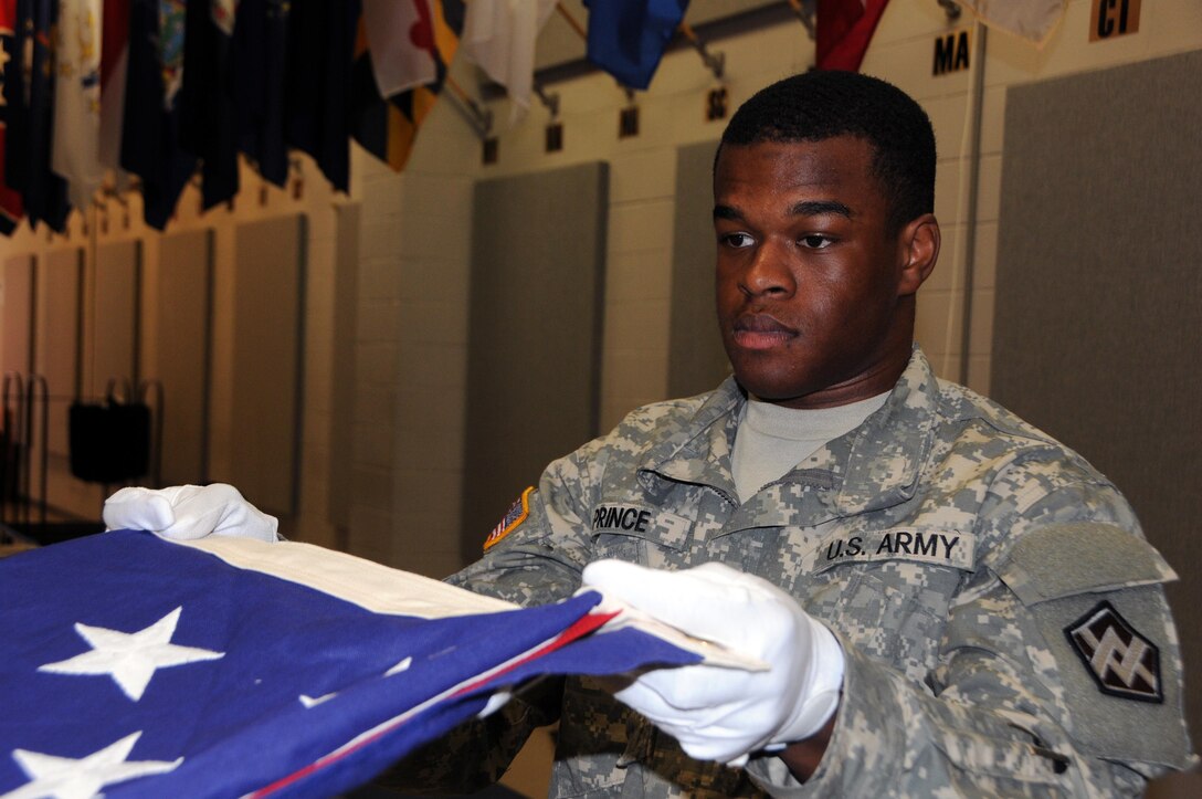 Spc. Jalen Prince, a transportation management coordinator from Elkton, Maryland currently assigned to the U.S. Army Reserve’s 319th Transportation Company, practices folding the U.S. flag April 20 during military funeral honors training at 99th Regional Support Command headquarters on Joint Base McGuire-Dix-Lakehurst, New Jersey.  The 99th RSC supports the casualty mission by providing support and assistance to families of Soldiers and Department of Army civilians reported as a casualty (deceased, missing, or whereabouts unknown).