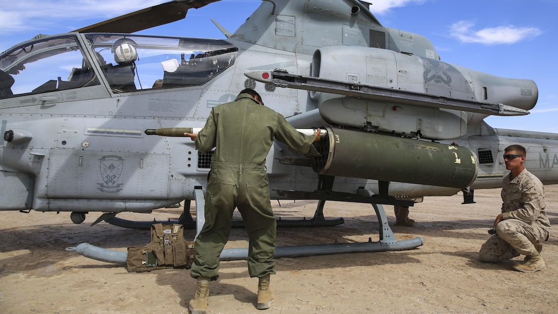 Ordnance Marines with Marine Aviation Weapons and Tactics Squadron 1 load ordnance to a AH-1Z Viper during forward arming refueling point operations as part of Assault Support Training 1 in support of the semiannual Weapons and Tactics Instructor Course 2-17, at the Chocolate Mountain Aerial Gunnery Range, California, April 17. Lasting seven weeks, WTI is a training evolution hosted by MAWTS-1 which provides standardized advanced and tactical training and certification of unit instructor qualifications to support Marine aviation training and readiness.