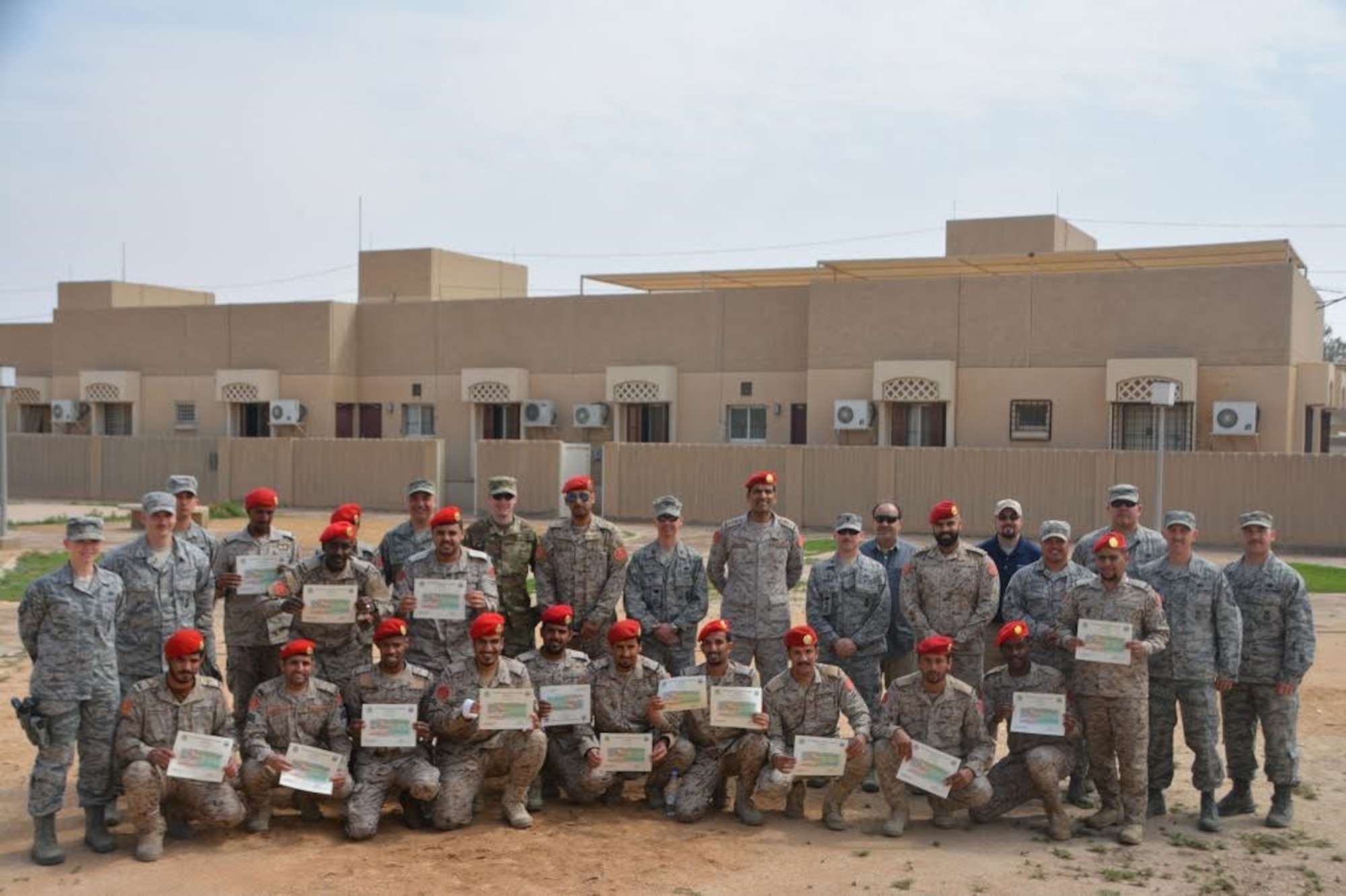 Members of the Saudi Arabia Ministry of Defense Military Police pose for a photo during graduation from a three-week training exercise with the 879th Expeditionary Security Forces Squadron at Eskan Village, Kingdom of Saudi Arabia, March 2, 2017. Airmen and Saudi police members trained in multiple areas of security protection, including: formations for escorting, identifying explosives and vehicle searches.  (Courtesy photo)