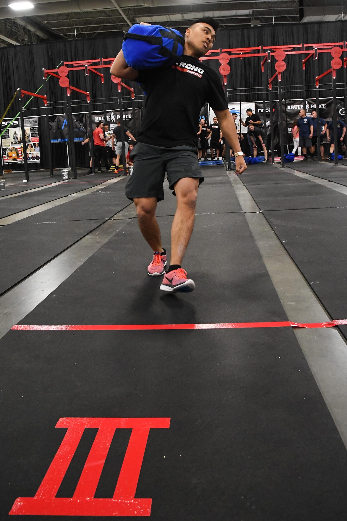 Elijah Carino performs a shuttle with 160 pounds on his shoulder during the ‘FitCon Frontline Throwdown’ at the Salt Palace in Salt Lake City, Utah, April 21. Each member of the four-person team ran back and forth six times, three times with the weight and three times without. (R. Nial Bradshaw/U.S. Air Force)