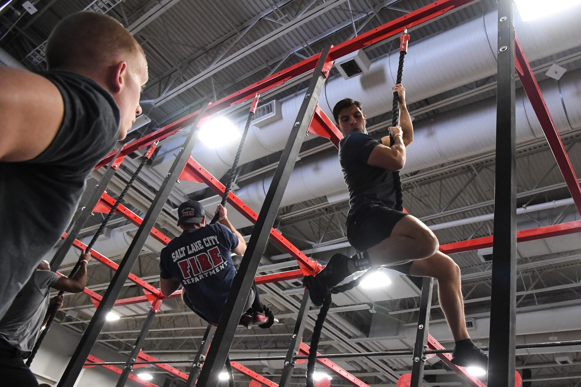 Juan Mendez performs climbs a rope during the ‘FitCon Frontline Throwdown’ at the Salt Palace in Salt Lake City, Utah, April 21. The four-person team took turns climbing the rope for 10 minutes. (R. Nial Bradshaw/U.S. Air Force)