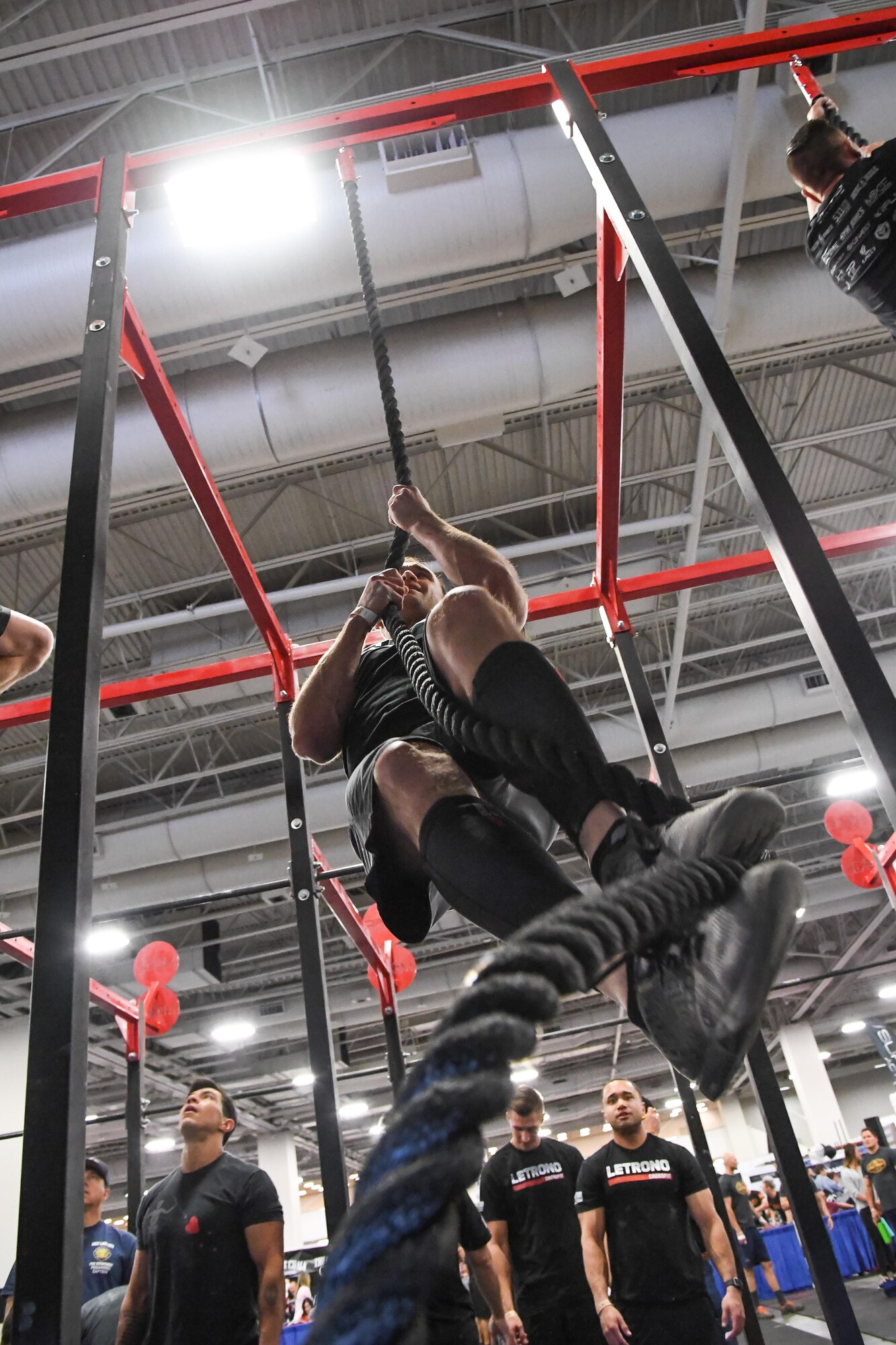 Brandon Charleson performs climbs a rope during the ‘FitCon Frontline Throwdown’ at the Salt Palace in Salt Lake City, Utah, April 21. The four-person team took turns climbing the rope for 10 minutes. (R. Nial Bradshaw/U.S. Air Force)